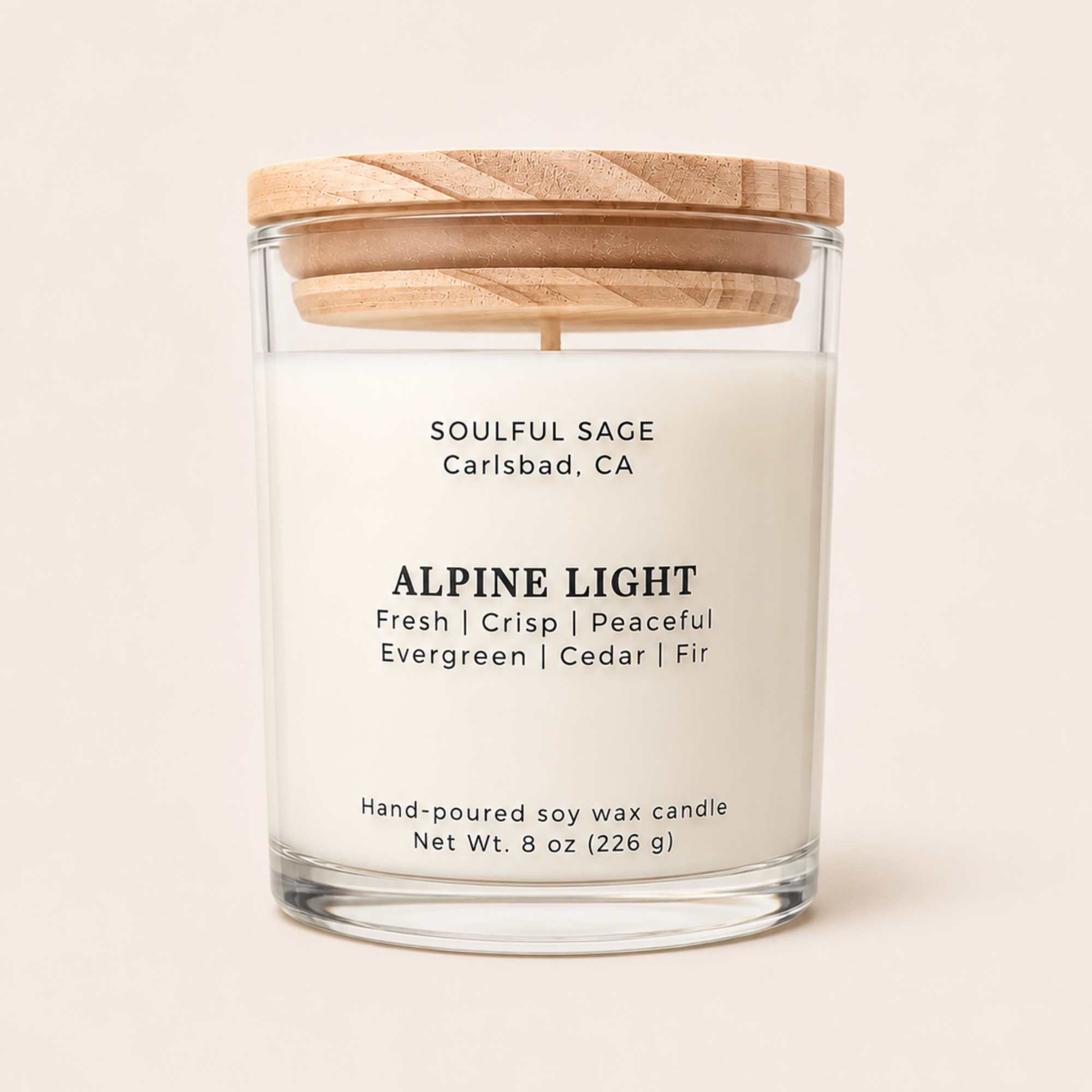 Alpine Light soy candle by Soulful Sage with evergreen, cedar, and fir notes in a clear glass jar with a natural wood lid.