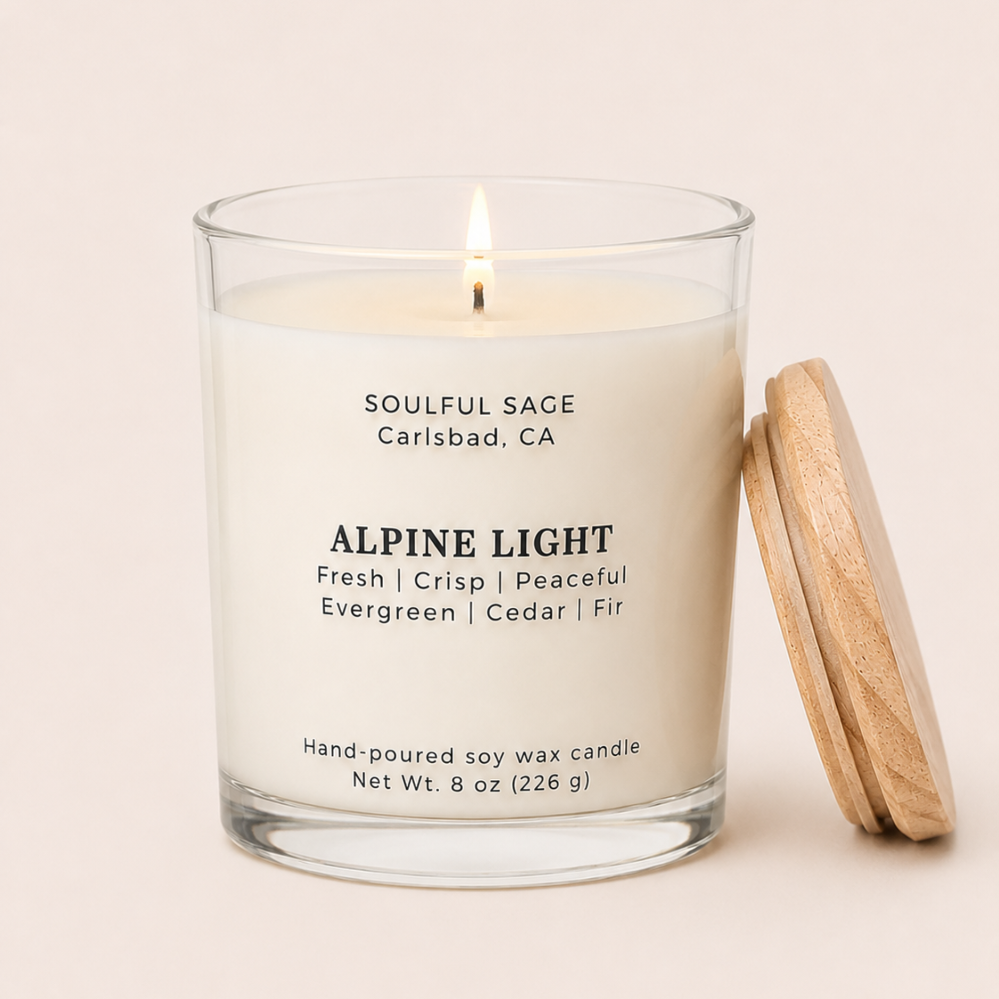 Lit Alpine Light soy candle by Soulful Sage with a full melt pool, evergreen, cedar, and fir notes, and a natural wood lid resting beside the glass jar.