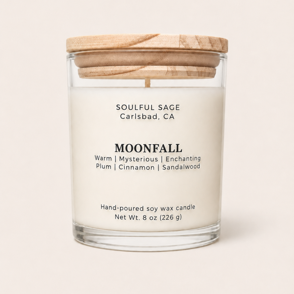 Moonfall soy candle by Soulful Sage with plum, cinnamon, and sandalwood notes in a clear glass jar with a natural wood lid.