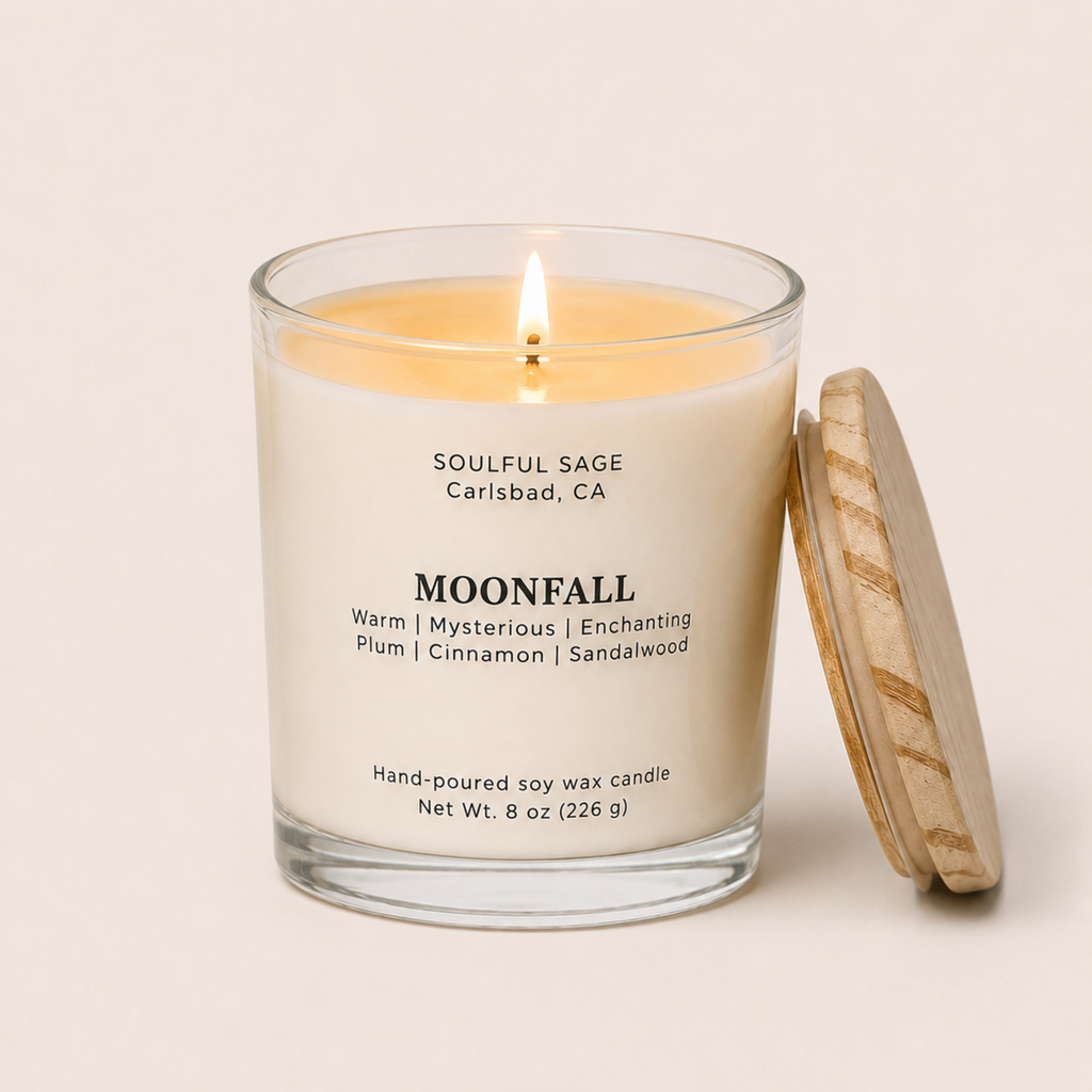 Lit Moonfall soy candle by Soulful Sage with a full melt pool, plum, cinnamon, and sandalwood notes, and a natural wood lid resting beside the glass jar.