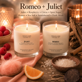Romeo and Juliet soy candles by Soulful Sage, lit with full melt pools and styled together with raspberries, citrus, spun sugar, sea salt, sandalwood, and warm candlelight
