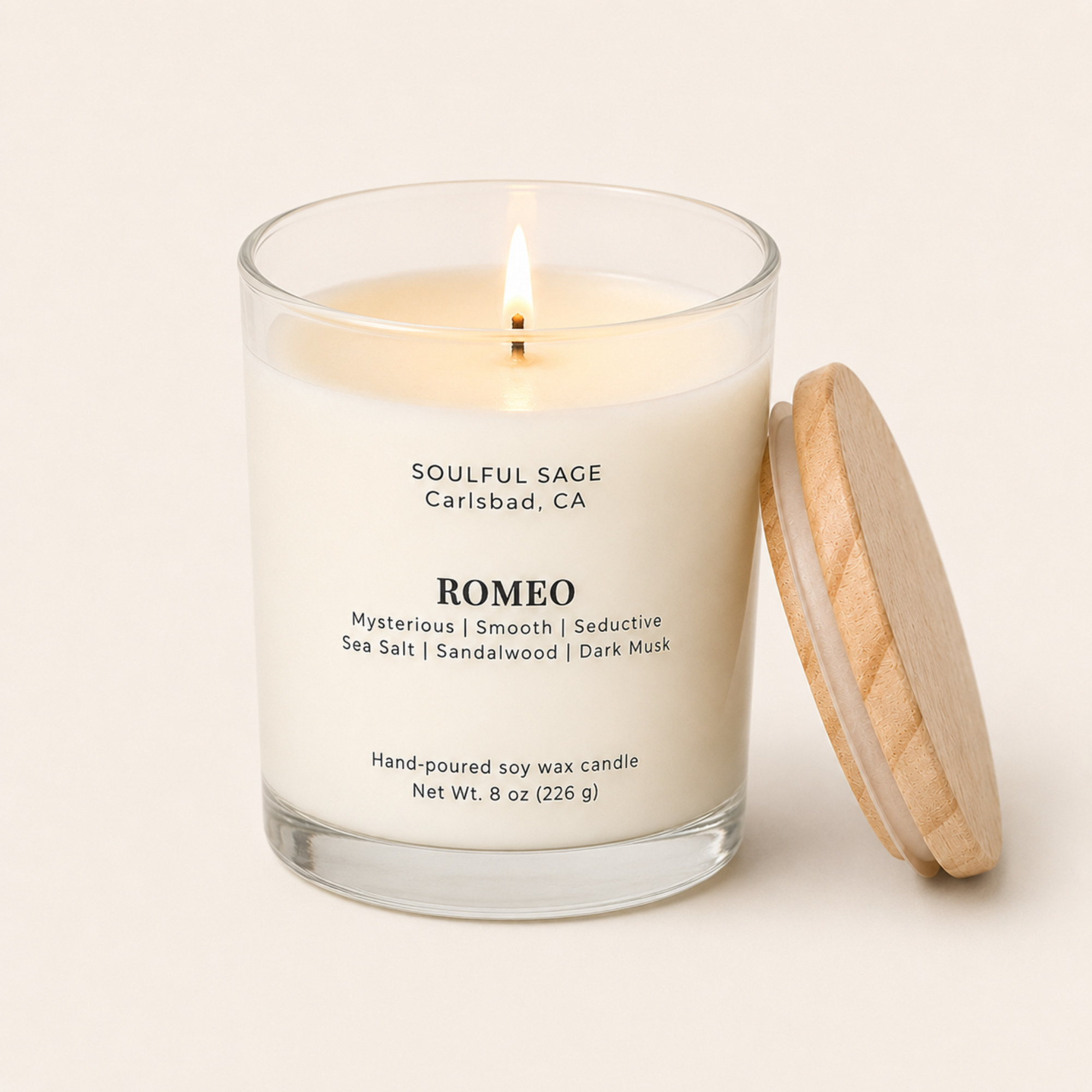 Lit Romeo soy candle by Soulful Sage with bamboo lid leaning on the side, full melt pool, and notes of sea salt, sandalwood, and dark musk.